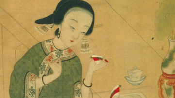 Footbinding - Chinese woman holding small shoe and looking at text