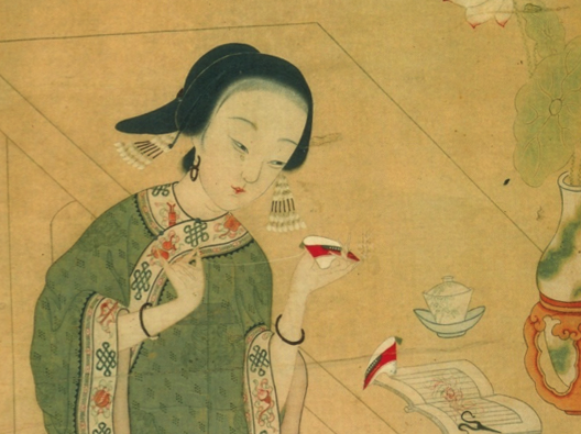 Footbinding - Chinese woman holding small shoe and looking at text